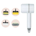 Green USB rechargeable electric cleaning brush with two brush heads on a kitchen counter