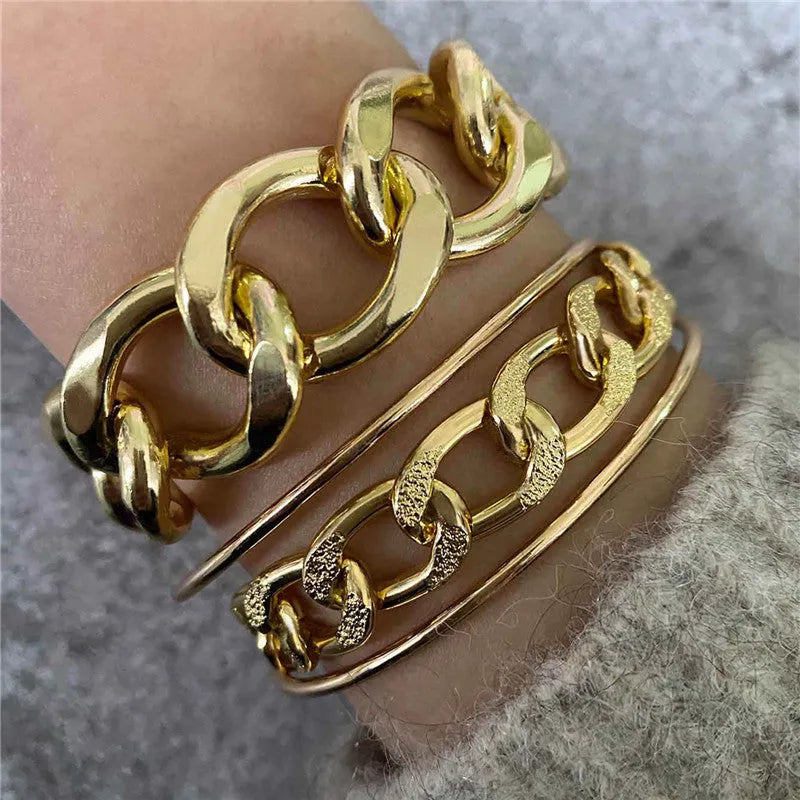 Three gold alloy double-layer thick chain bracelets with geometric design laid out flat