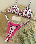 Women's printed bikini swimsuit on a hanger, showing briefs style with quick-drying fabric and cotton lining.