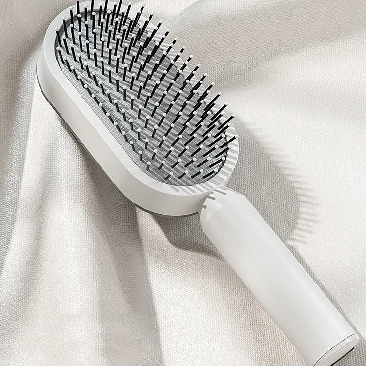 Self-cleaning hair brush with air cushion bristles in black gold, white, or purple colours