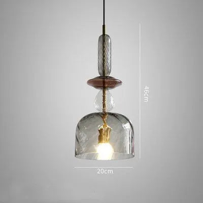Glass droplet chandelier with adjustable height, hanging above a bar counter.