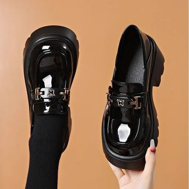 Black women's slip-on shoes with a skull pattern, chunky square heel, and round toe on a white background.