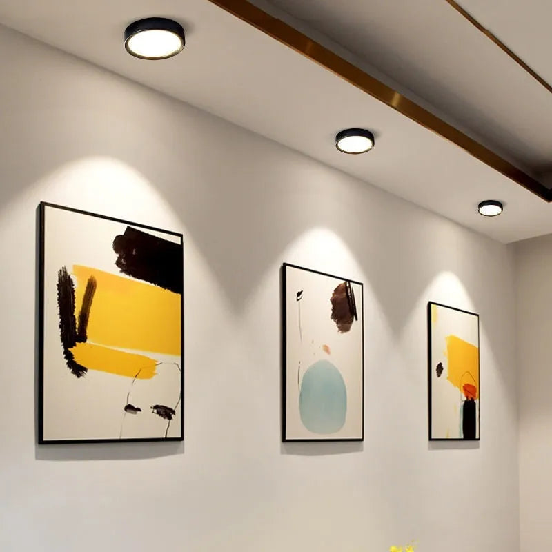Ultra-thin surface mounted LED downlight in a choice of seven colours including black, white, gold, and pink.