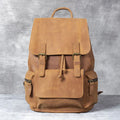 Brown genuine cowhide leather backpack with double shoulder straps and a soft handle.
