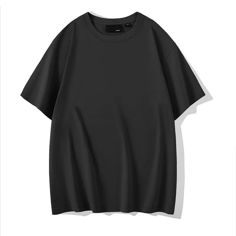 Man wearing a solid colour loose-fit cotton T-shirt with drop shoulder sleeves.