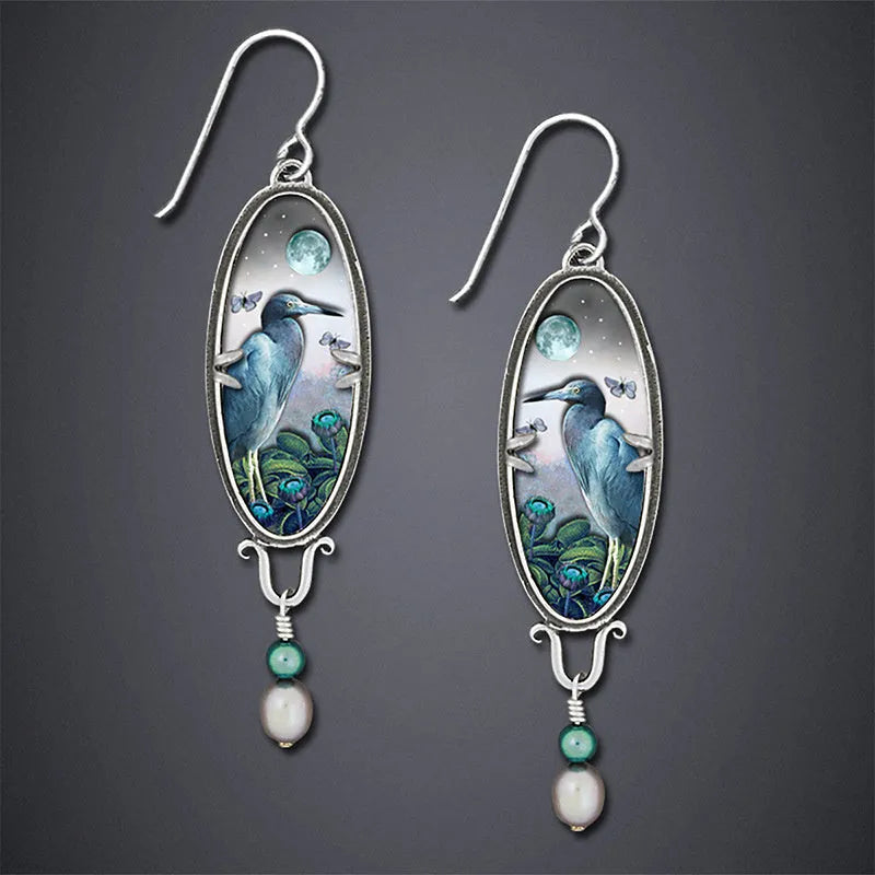 Silver-coloured drop shape earrings with a retro bird and flower electroplated design.