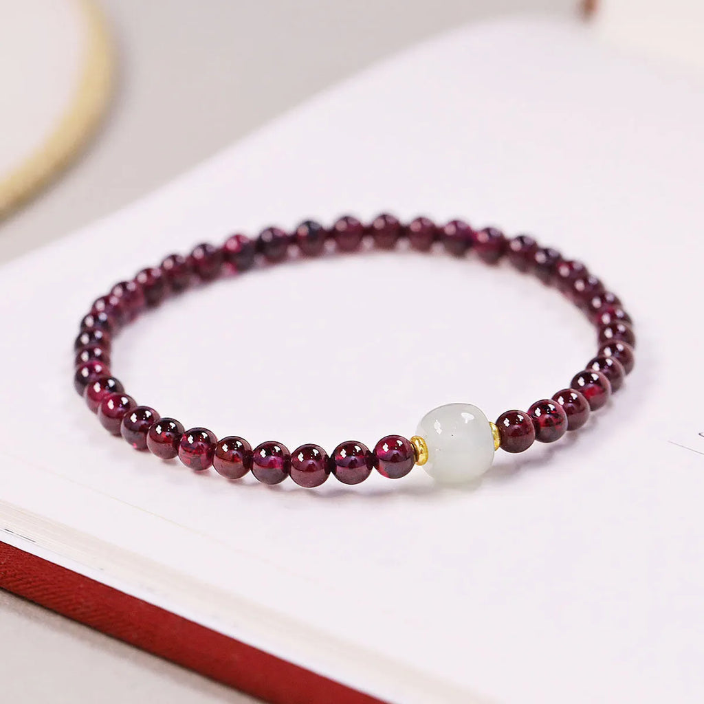 Natural garnet bracelet with U-shaped design showing garnet and dream garnet colour options