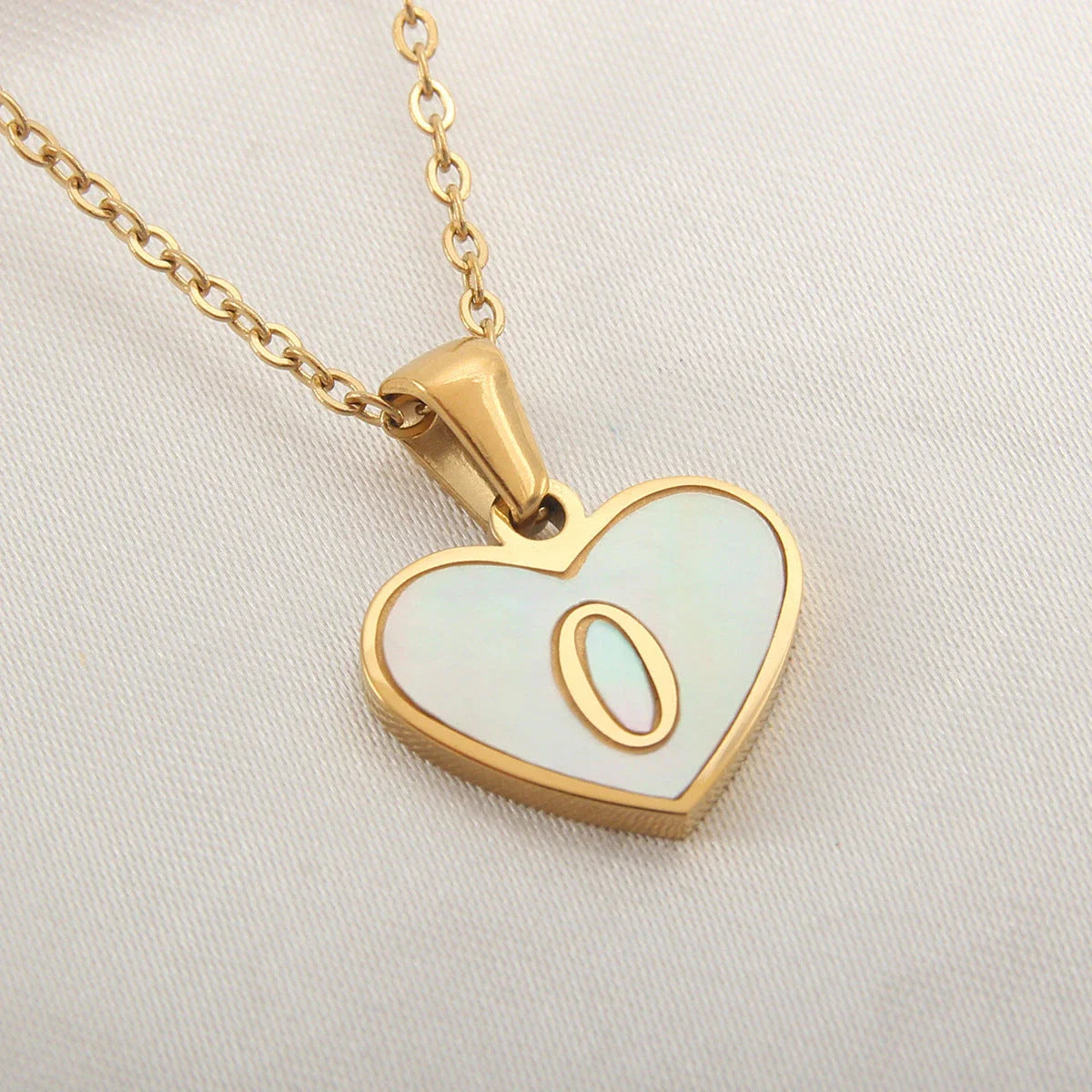 A personalized heart-shaped necklace with a 26-letter charm, crafted from high-quality stainless steel and gold plating.