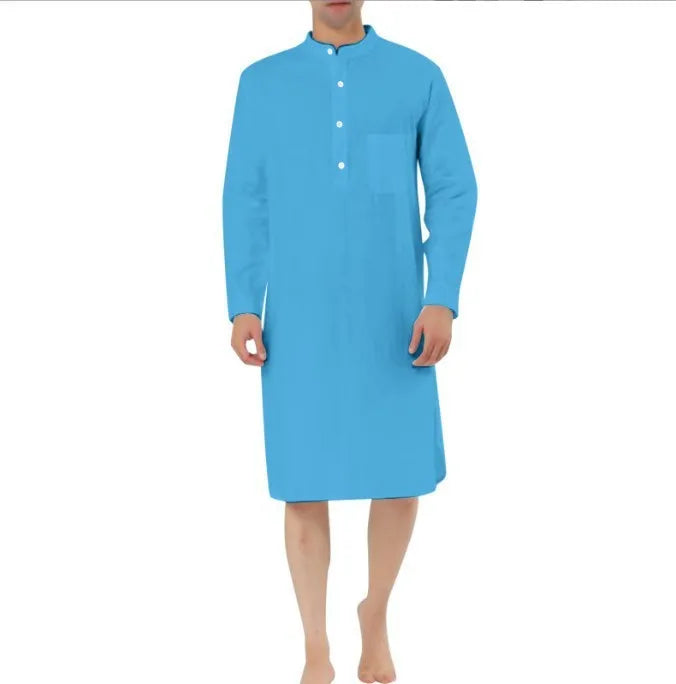 Man wearing a light blue cotton shirt robe with front pockets, showing the full-length opening and relaxed fit.