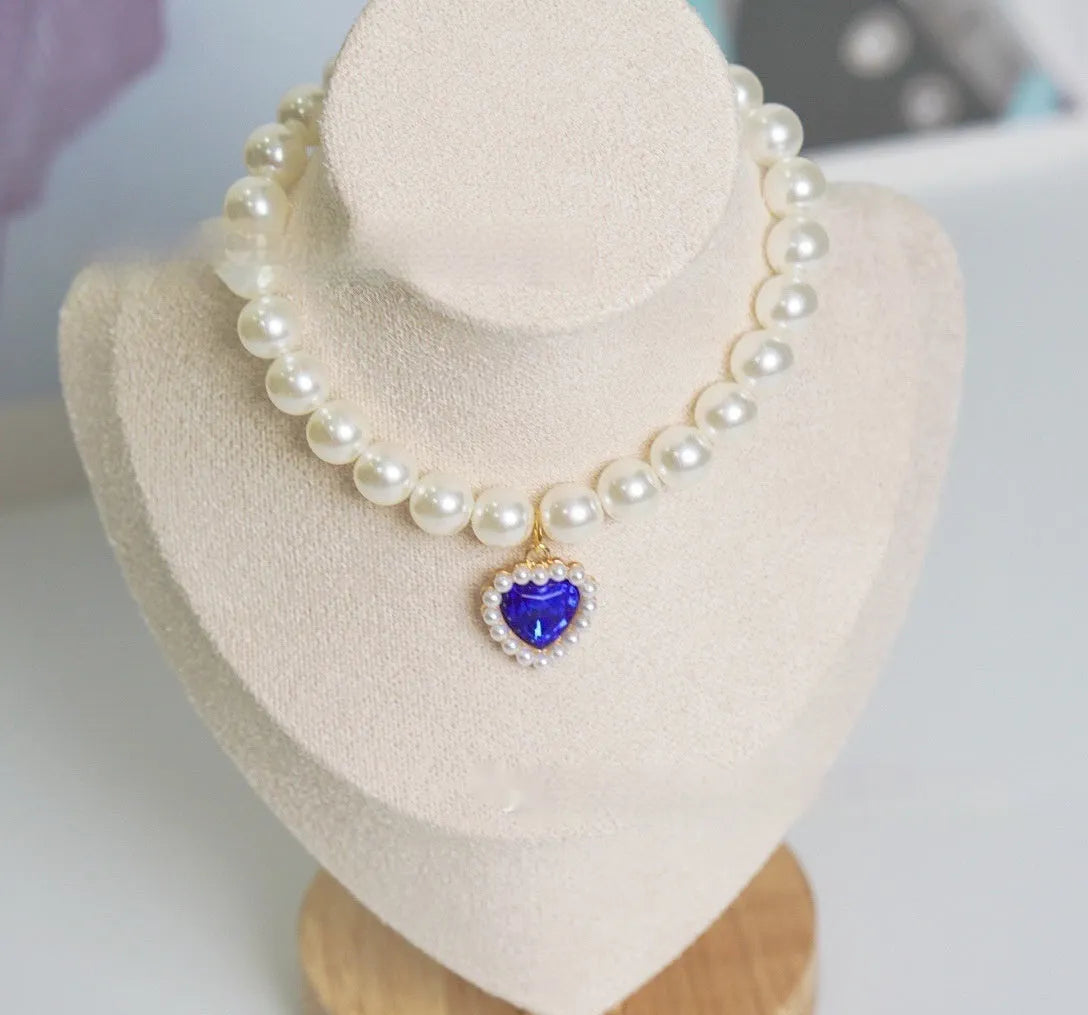 A decorative gem-style cat collar in plastic alloy resin, shown in multiple solid colours with adjustable sizing.