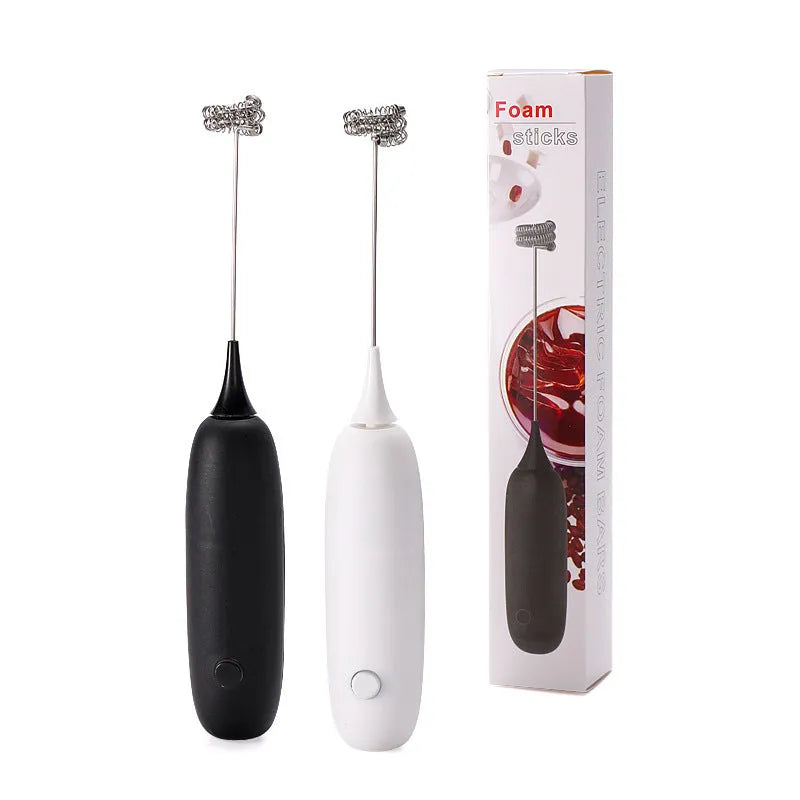 Hand-held electric milk frother and blender in black and white colour options on a kitchen counter.