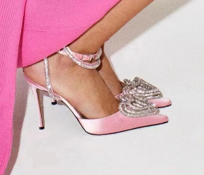Women's pointed toe sandals with satin upper, heart-shaped rhinestones, and adjustable cross-belt straps.