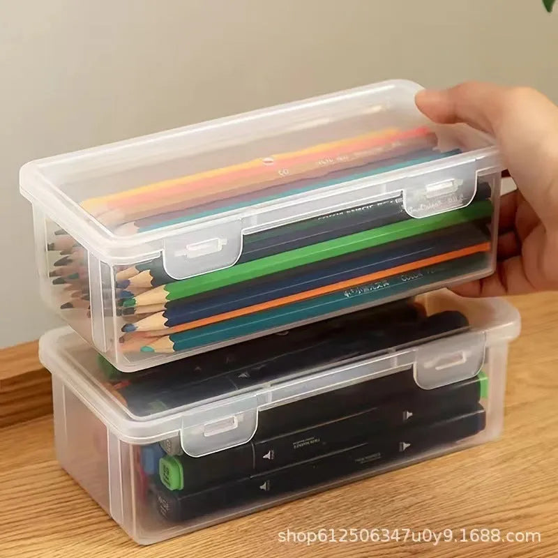 Transparent plastic pencil storage box for stationery organisation with visible drawing supplies inside