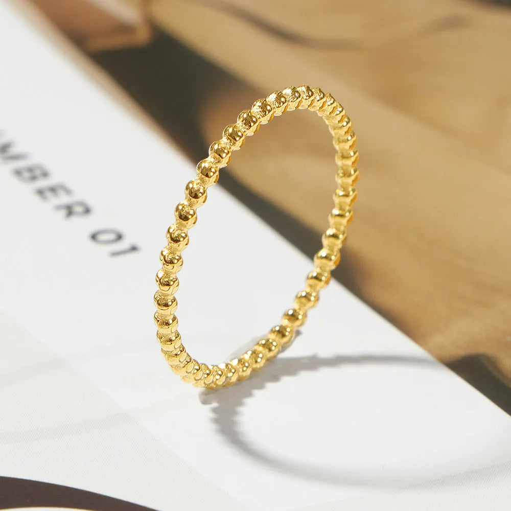 Titanium steel plain circle ring in gold finish on a neutral background