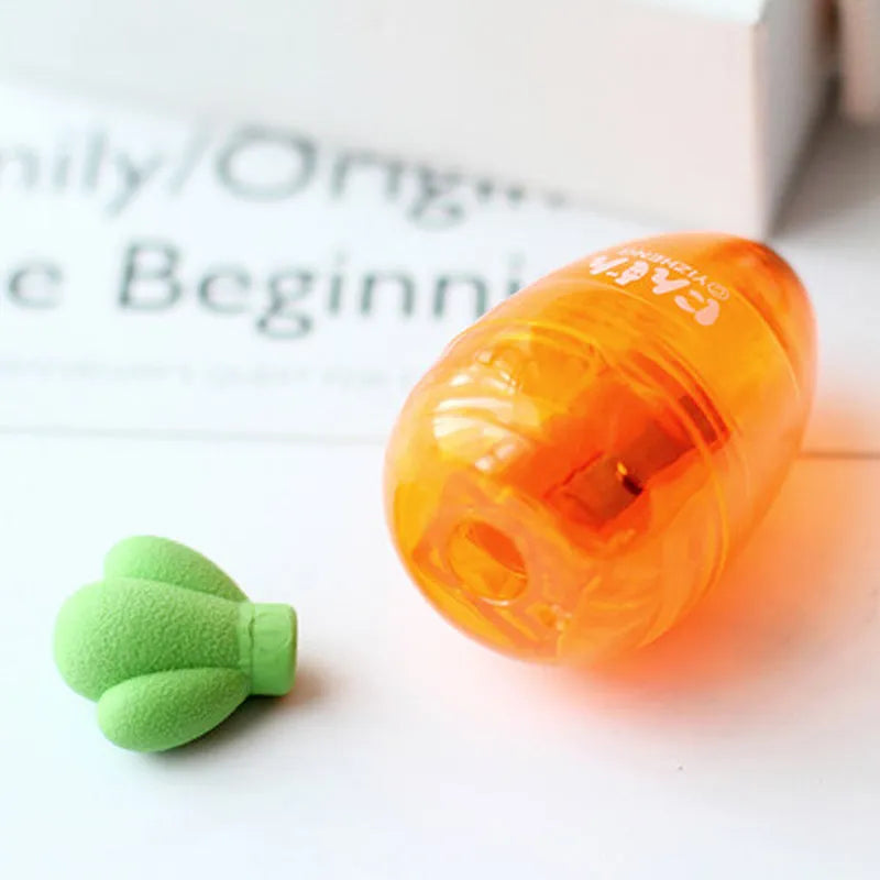 Orange carrot-shaped plastic pencil sharpener with green top, 7cm total length