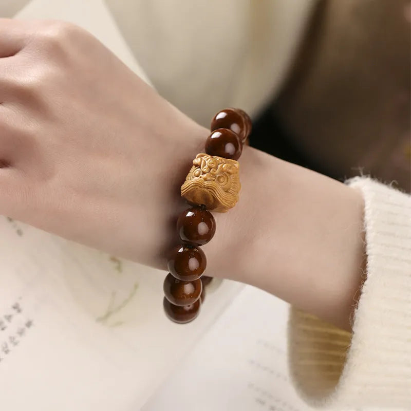 Hand-woven beaded circle bracelet with 13mm round beads in ivory nut, sandalwood, or yellow gradient bodhi style.
