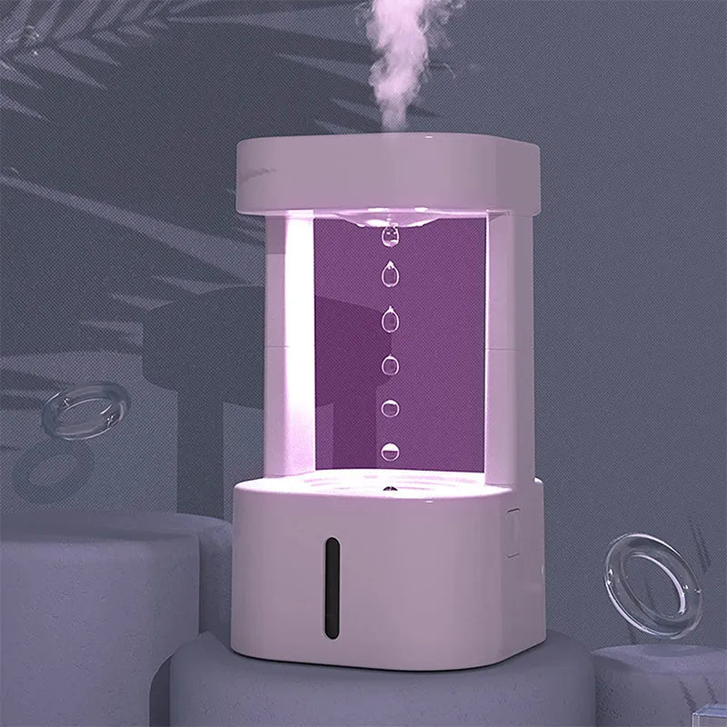 Anti-gravity water drop humidifier with coloured lights on a desk, showing water droplets appearing to float.