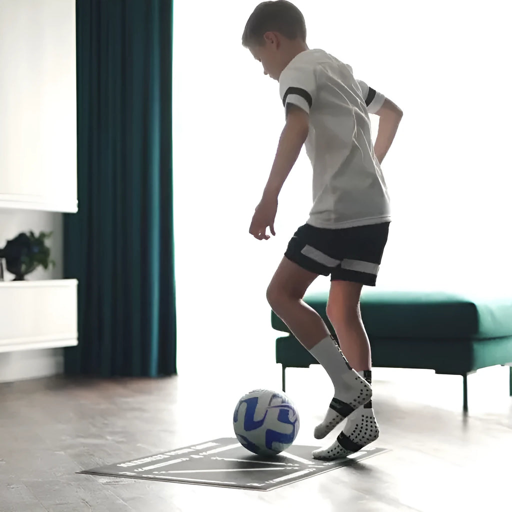 Black rectangular football training mat on grass for non-slip skills practice