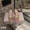 Women's black patent leather pointed stiletto heels with pearl decoration on the upper.