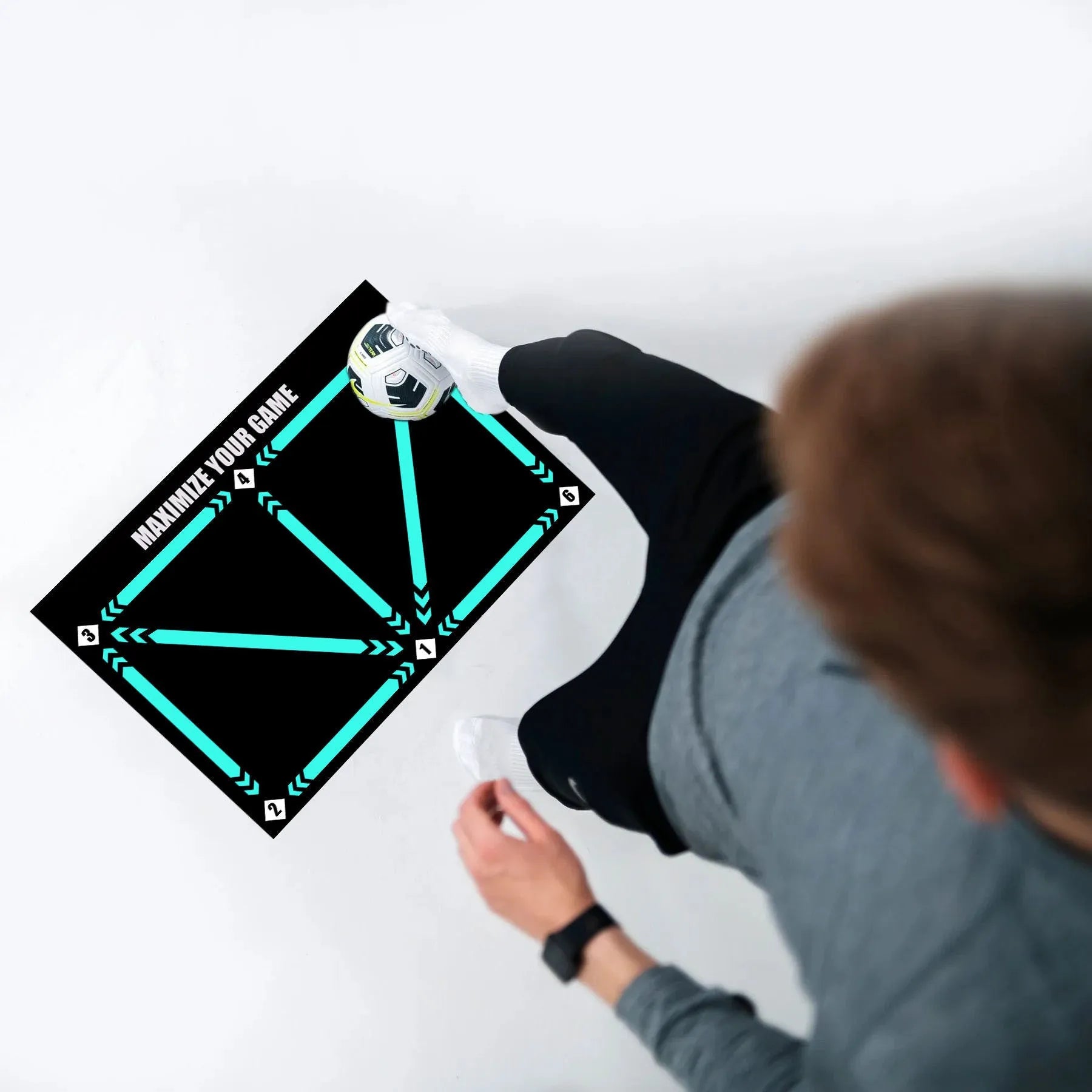 Black rectangular football training mat on grass for non-slip skills practice