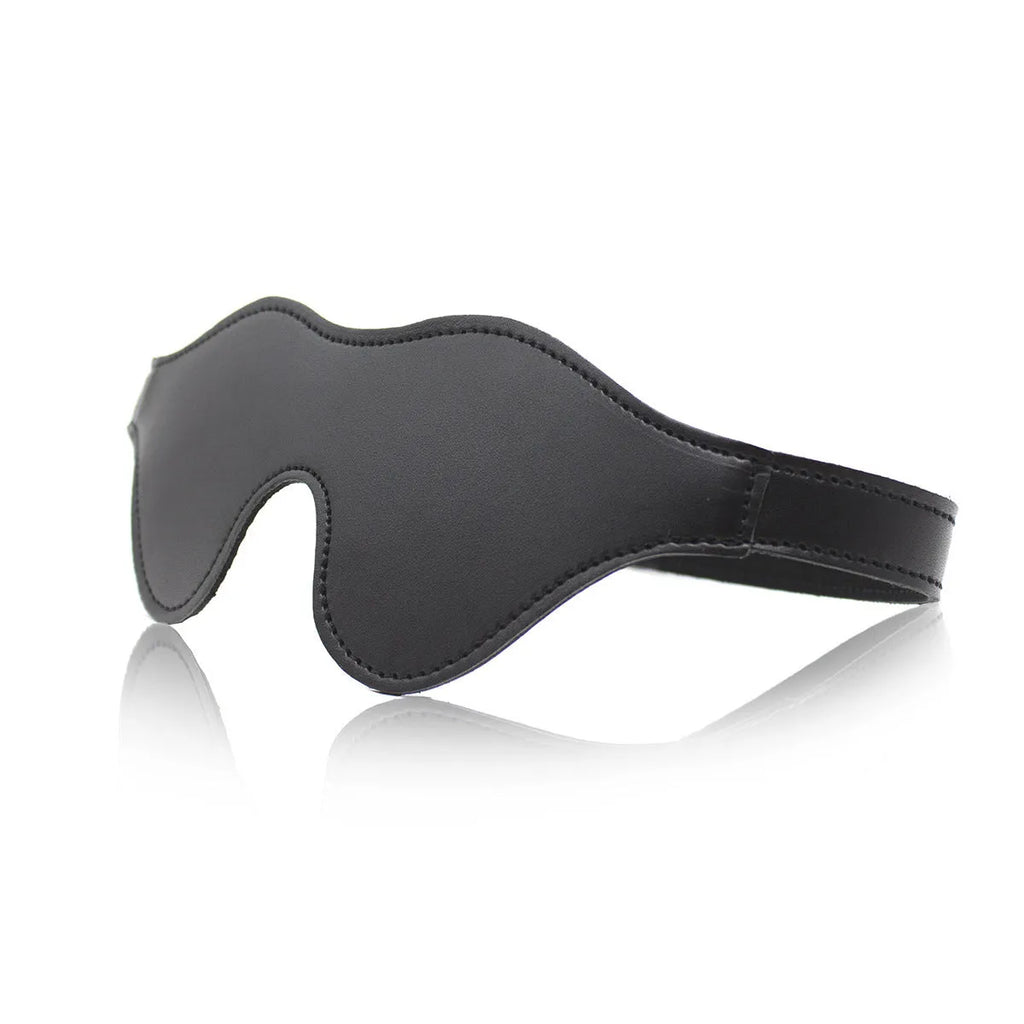 Women's black leather velcro eye mask blindfold showing three-dimensional shape and metal hardware.