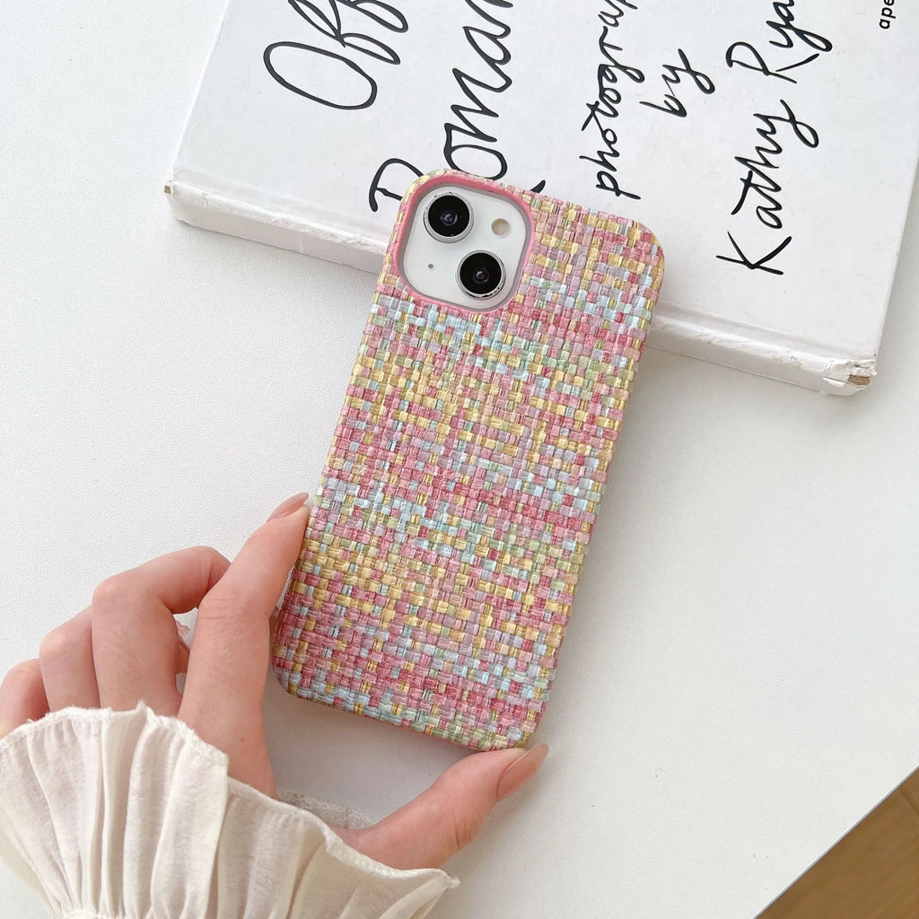 Hand-woven plaid TPU phone case in pink, shown on iPhone, with textured grip pattern and all-inclusive edges.