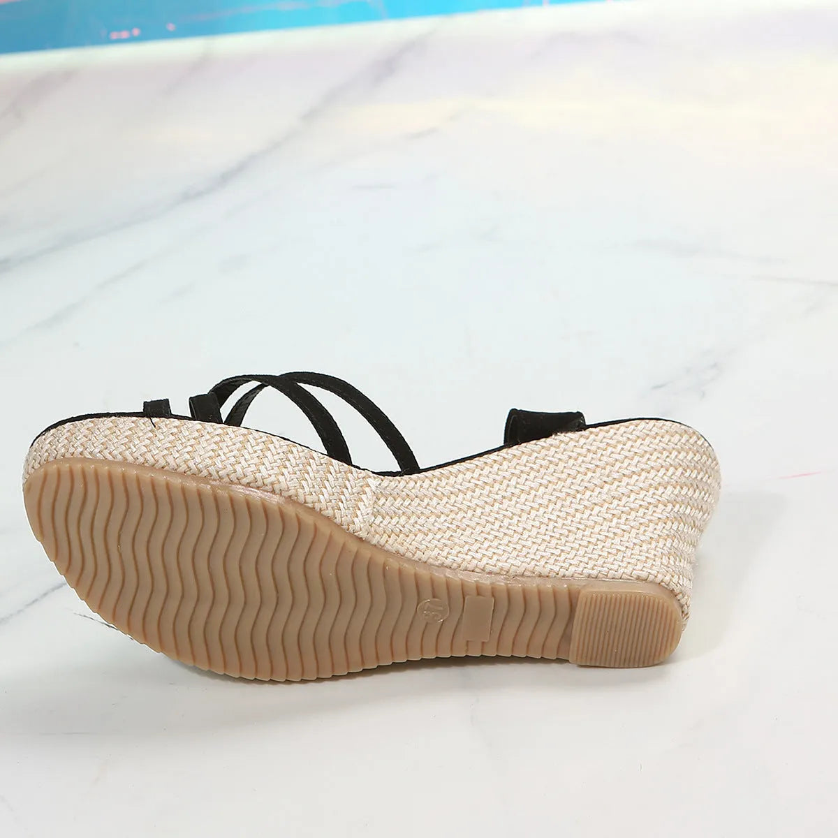 Women's beige and black cloth wedge sandals with a fish mouth open toe design.