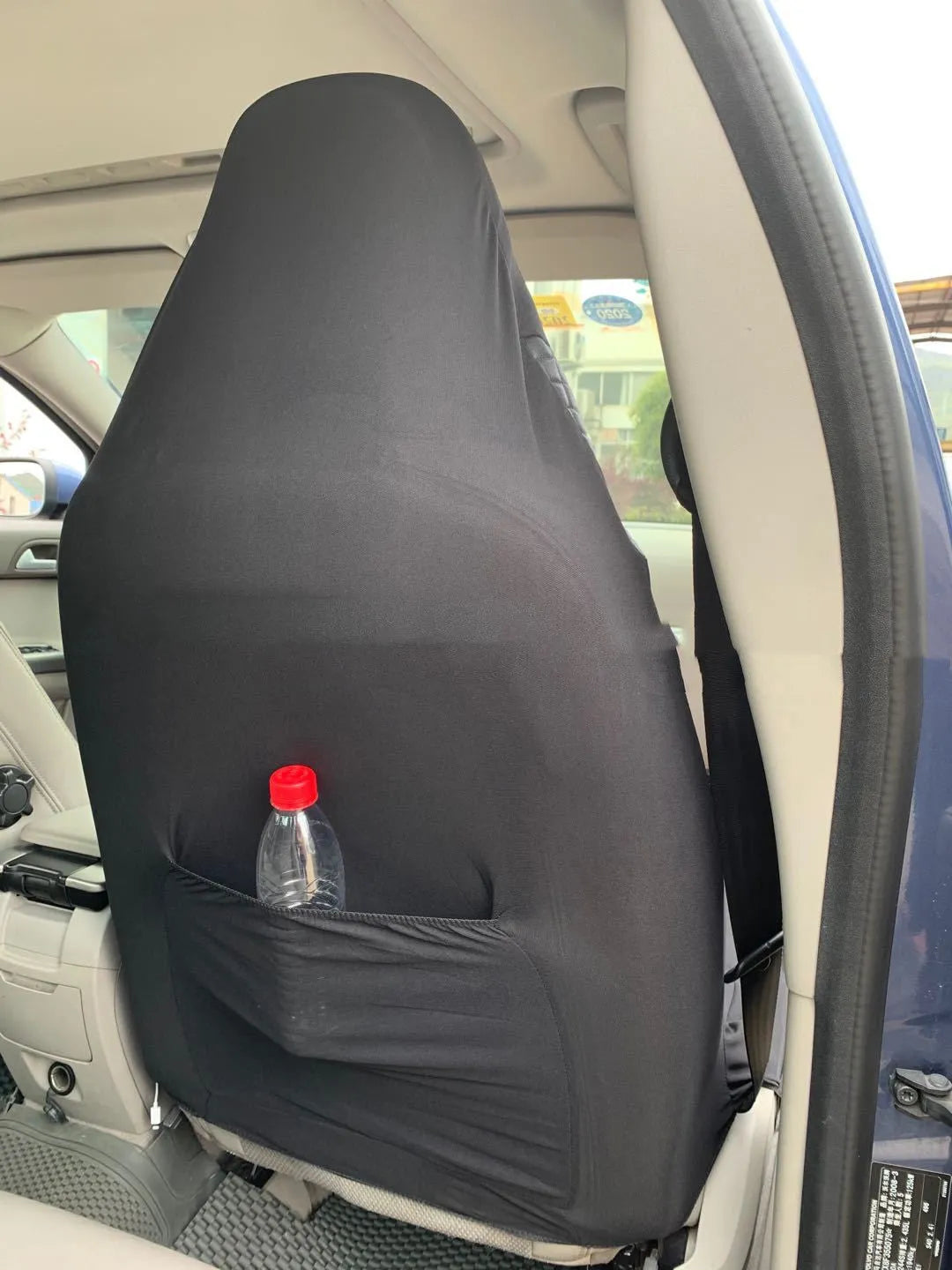 Black quilted universal car seat cover made from PU material on a car seat.
