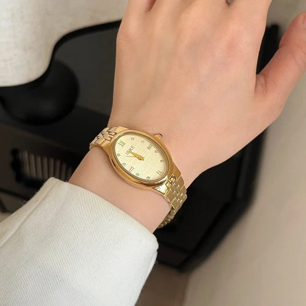 Oval dial watch with 37mm case, 10mm thickness, dot markers, and stainless steel butterfly clasp in gold or silver