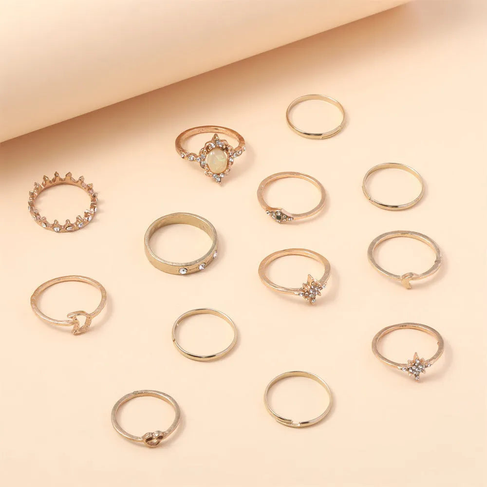 Vintage star and moon 13-piece ring set with opal and rhinestone accents in gold or silver electroplated zinc alloy