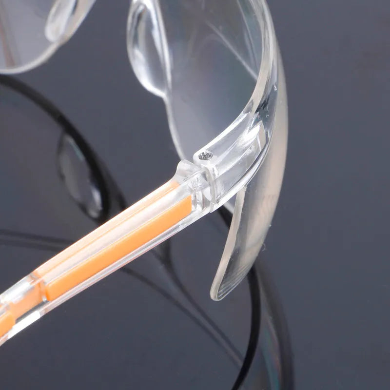 Transparent safety goggles with yellow frame made from impact-resistant polycarbonate