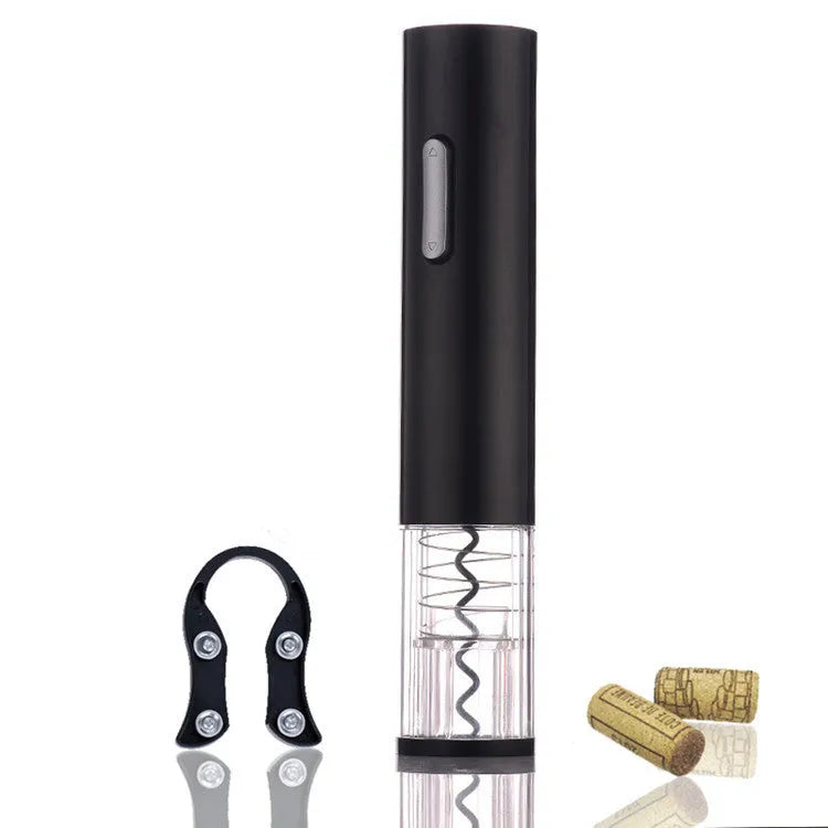 Black automatic electric wine bottle opener with foil cutter on a wooden table next to a wine bottle.