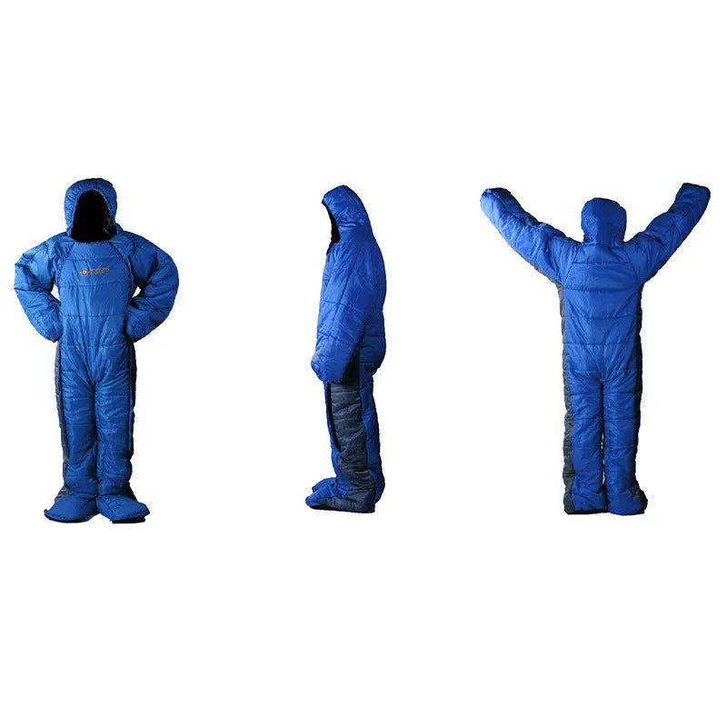 Blue gray patchwork humanoid sleeping bag on grass, legs separated for walking, mummy hood zipped with fill visible.