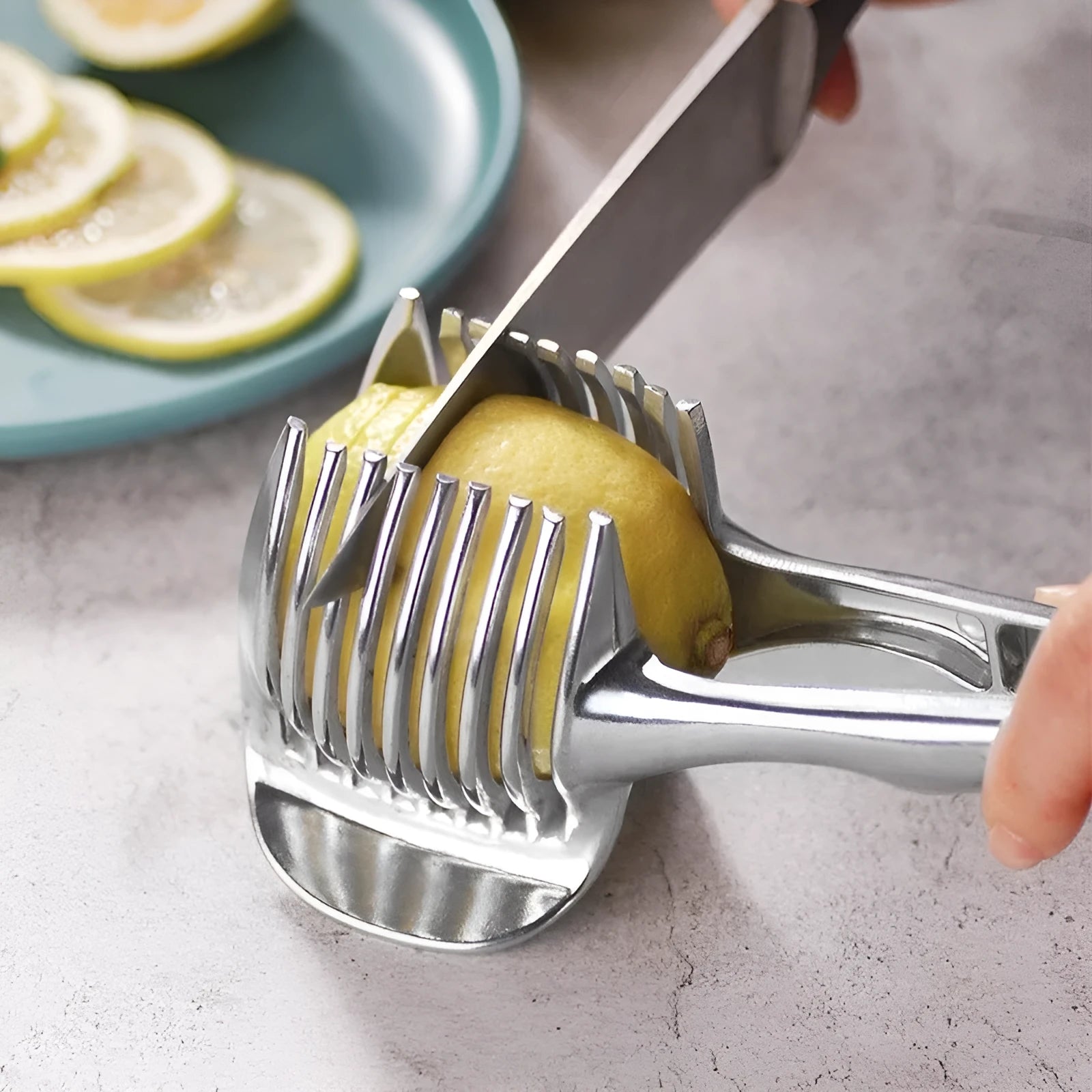 Silver-coloured plastic foldable lemon slicer kitchen gadget for cutting fruits and cakes