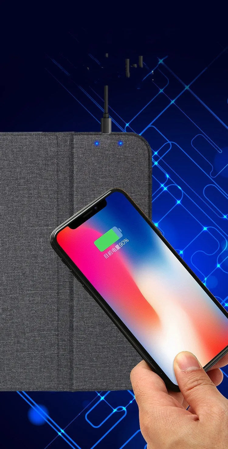 Black 2-in-1 wireless charging mouse pad on a desk with a phone resting on the built-in bracket