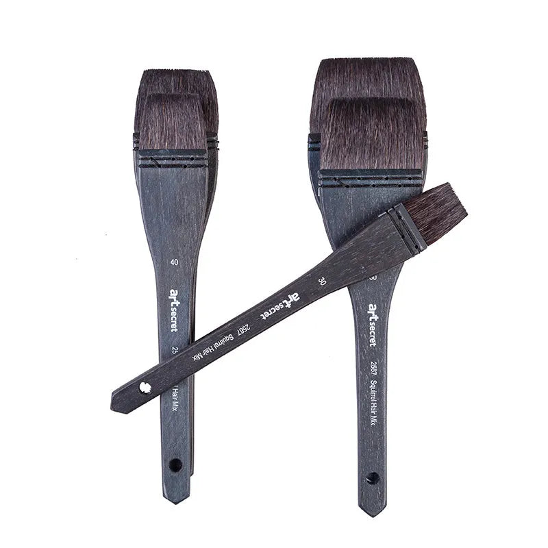 Squirrel hair makeup brush with natural wood handle on a clean surface.