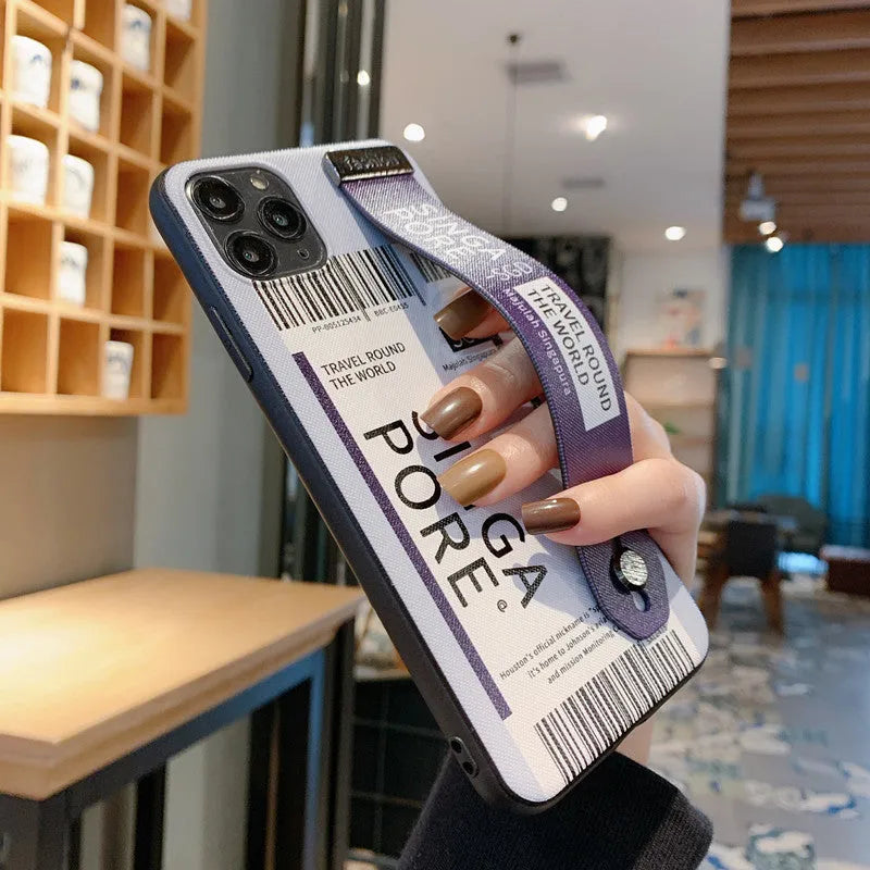 Purple mobile phone case for Apple iPhone with an attached black wristband lying flat.