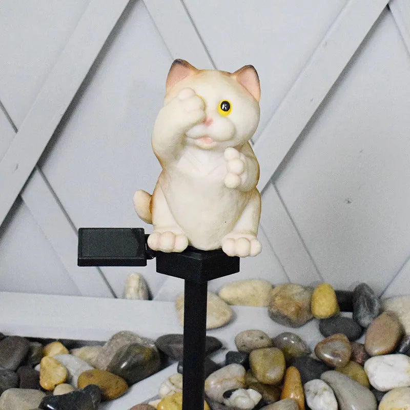 Brown resin cat-shaped solar garden light for outdoor decorative lighting.