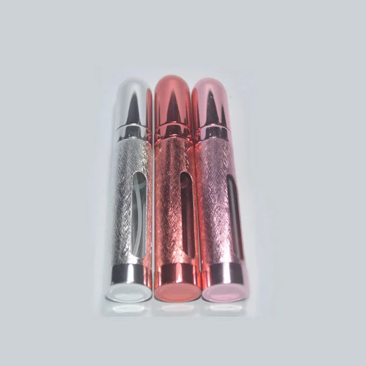 Slender silver aluminium travel perfume bottle with glass liner, shown next to a ruler indicating 115mm length.