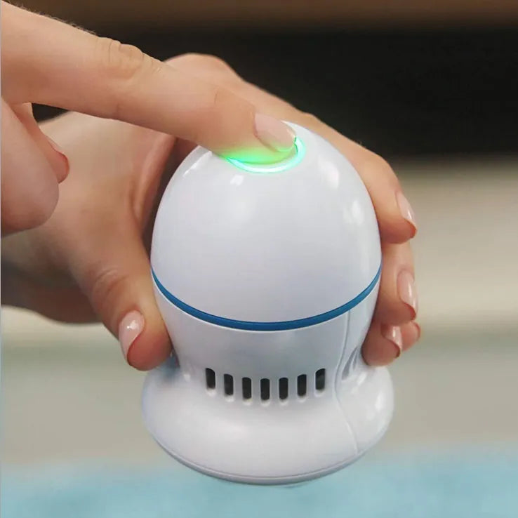 Beige and white USB-charged electric foot file grinder with vacuum system and two diamond grinding heads.