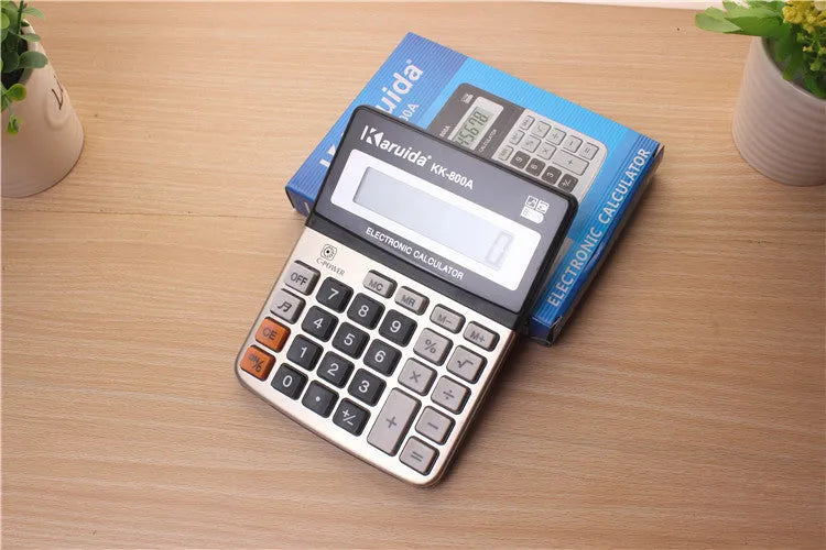 Silver aluminium desktop calculator with compact dimensions approximately 14.5 x 11 x 2.5 cm on a desk