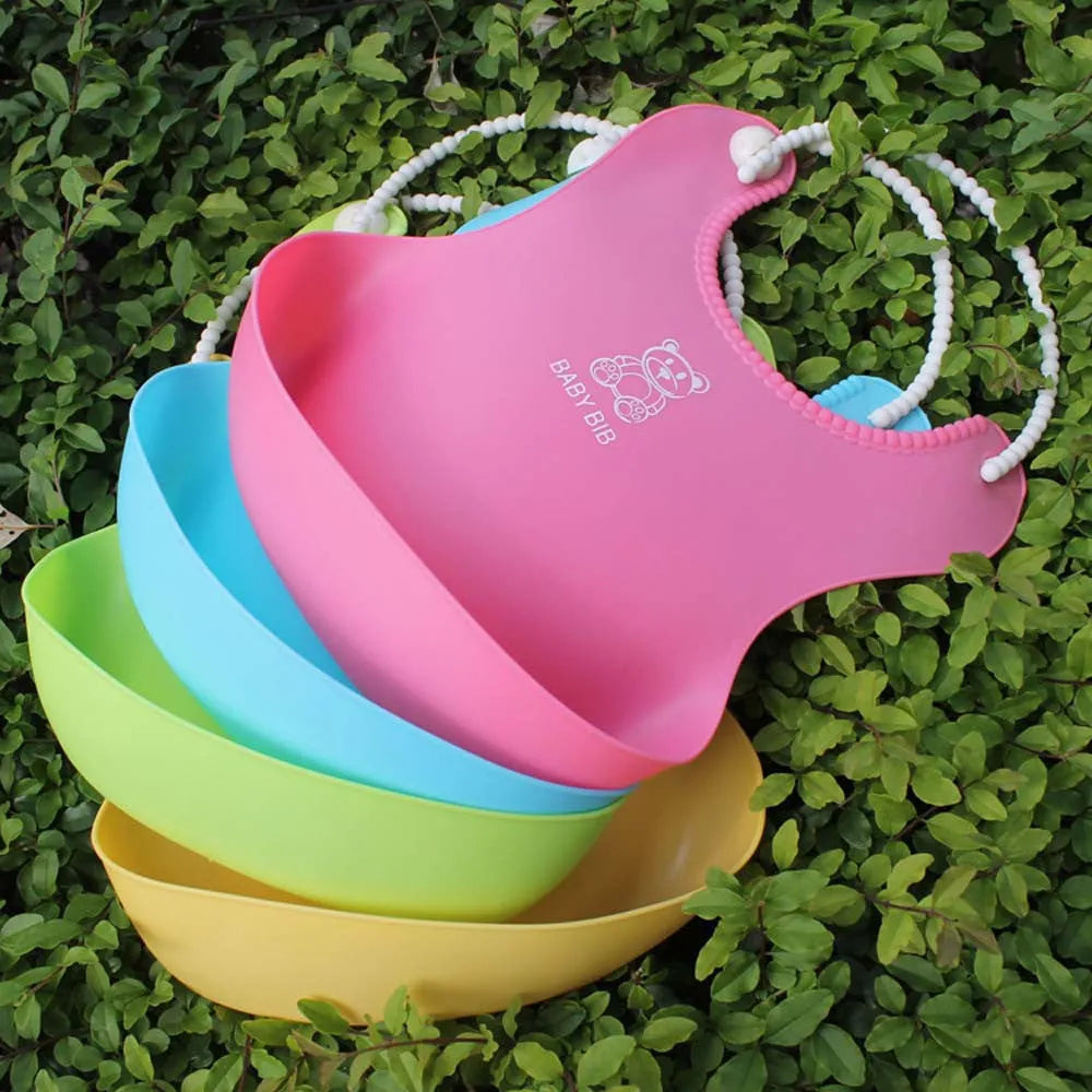 Baby soft silicone bib in pink with cartoon pattern, adjustable closure, 27x21cm