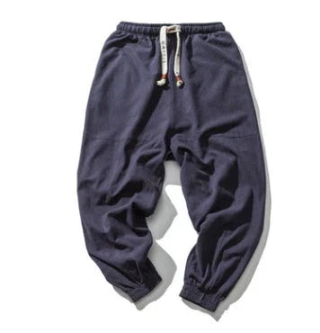 Men's cotton jogger pants with drawstring waist, side pockets, and tapered legs in various colors