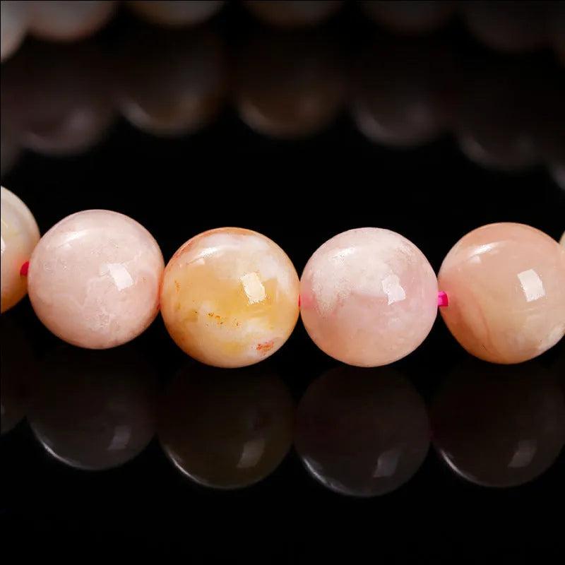 Cherry agate bracelet in natural cherry blossom colour with round geometric beads.