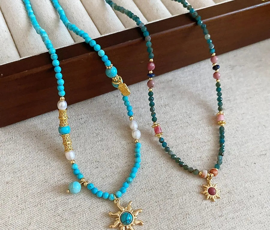 Freshwater pearl necklace with stone sun pendant on clavicle chain, blue or golden pink colour options