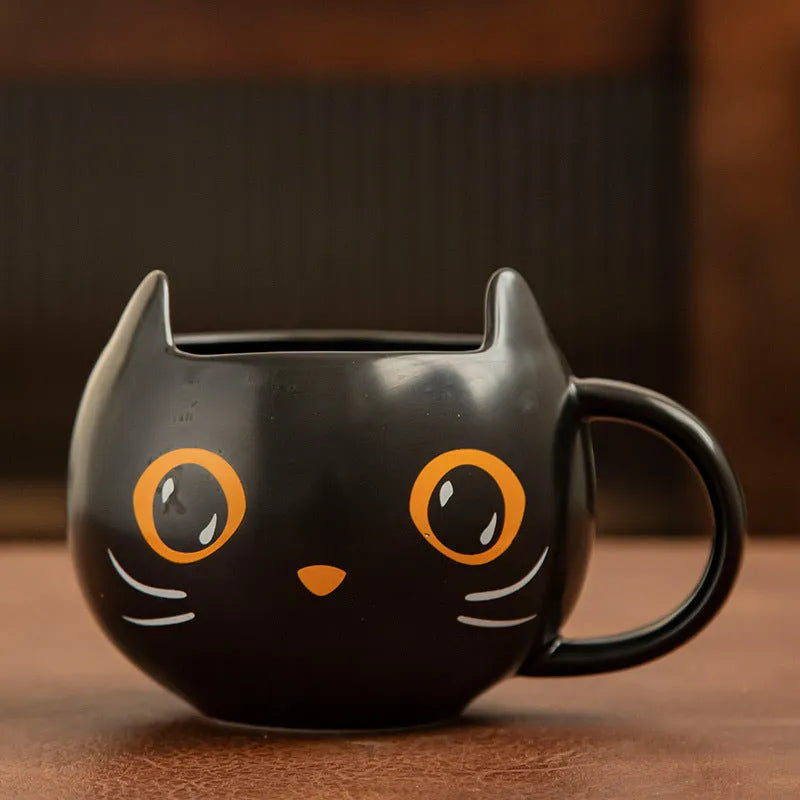 Black ceramic Halloween pumpkin couple mug with 355ml capacity and cat-shaped spoon lid.