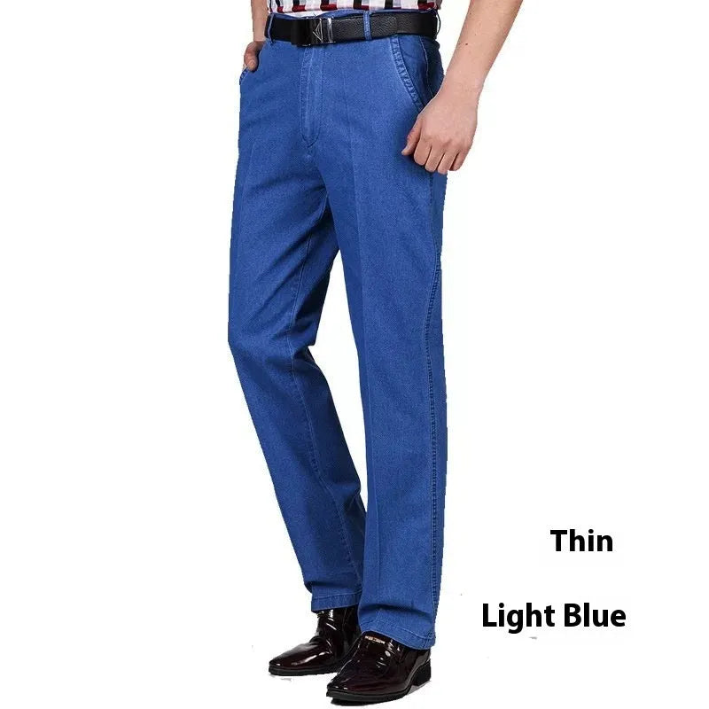 Men's loose fit high waist blue denim jeans on a plain background.