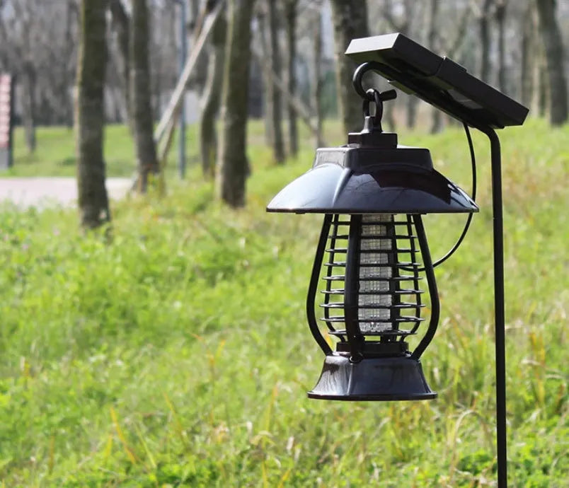 White outdoor solar mosquito lamp with solar panel and LED light beads for garden insect control.