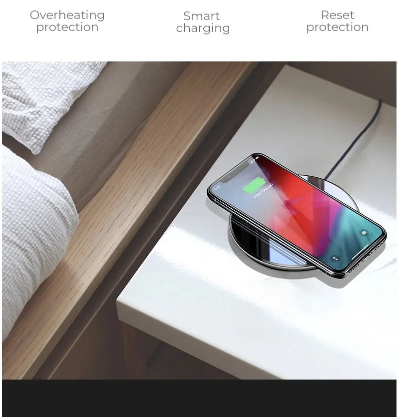 Black QI wireless charging pad with smooth plastic surface and silicone non-slip base