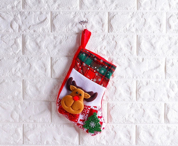 Colorful Christmas ornament-themed socks in a variety of designs, including an elk, bear, elderly person, and snowman.